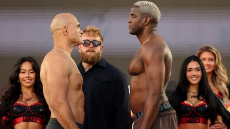 Former-UFC-heavyweight-champion-Junior-Dos-Santos,-left,-stares-at-Olympic-taekwondo-bronze-medallist-Robelis-Despaigne-with-promoter-Jake-Paul-in-the-middle
