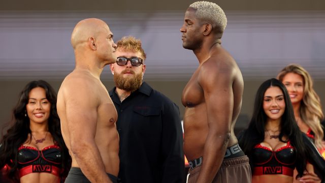 Former-UFC-heavyweight-champion-Junior-Dos-Santos,-left,-stares-at-Olympic-taekwondo-bronze-medallist-Robelis-Despaigne-with-promoter-Jake-Paul-in-the-middle