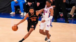 New York Knicks guard Mikal Bridges (25) drives past Philadelphia 76ers guard Tyrese Maxey (0) during the first half of Game 2 in a second-round NBA basketball playoffs series, Wednesday, May 6, 2026, in New York. (Yuki Iwamura/AP)