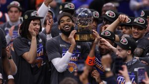New York Knicks center Karl-Anthony Towns, center, and teammates celebrate after winning Game 4 in the Eastern Conference finals NBA basketball playoffs series against the Cleveland Cavaliers in Cleveland, Monday, May 25, 2026.(AP Photo/Tim Phillis)