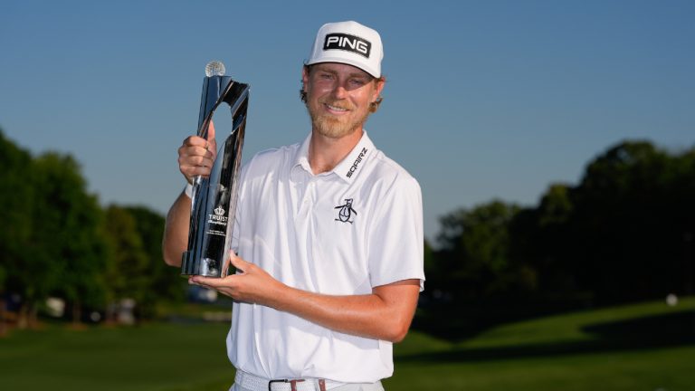Kristoffer Reitan, of Norway, poses with the trophy after winning the Truist Championship golf tournament at the Quail Hollow Club, Sunday, May 10, 2026, in Charlotte, N.C. (Chris Carlson/AP)