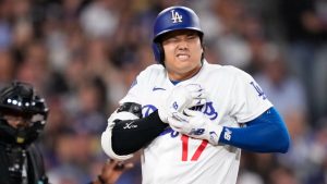 Los Angeles Dodgers' Shohei Ohtani reacts after being hit by a pitch as home plate umpire Malachi Moore watches during the fourth inning of a baseball game against the Colorado Rockies, Tuesday, May 26, 2026, in Los Angeles. (Mark J. Terrill/AP)