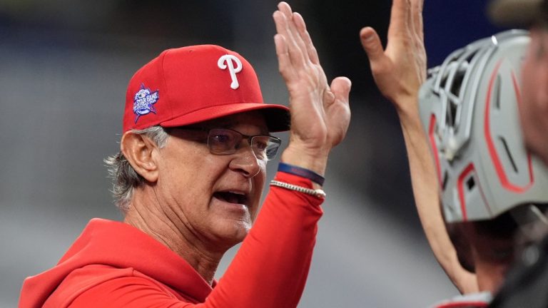 Philadelphia Phillies interim manager Don Mattingly high fives players at the end of a baseball game against the Miami Marlins, Monday, May 4, 2026, in Miami. (AP Photo/Rebecca Blackwell)