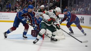 Minnesota Wild left wing Kirill Kaprizov, front right, collects the puck as Colorado Avalanche defensemen Brett Kulak, front left, and Cale Makar, back, cover in the second period of Game 1 of an NHL hockey Stanley Cup second-round playoff series Sunday, May 3, 2026, in Denver. (David Zalubowski/AP)