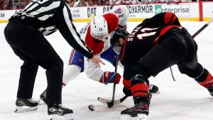 Montreal Canadiens' Nick Suzuki (14) faces off against Carolina Hurricanes' Jordan Staal (11) during overtime period in Game 2 of the Eastern Conference finals NHL hockey Stanley Cup playoff series in Raleigh, N.C., Tuesday, May 26, 2026. (Karl DeBlaker/AP)