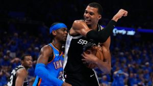 Oklahoma City Thunder guard Shai Gilgeous-Alexander (2) and San Antonio Spurs forward Victor Wembanyama (1) battle for a rebound during the second half of Game 1 in a third-round NBA basketball playoffs series Monday, May 18, 2026, in Oklahoma City. (Tony Gutierrez/AP)