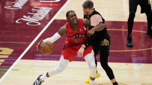 Toronto Raptors forward RJ Barrett (9) and Cleveland Cavaliers guard Sam Merrill, right, get tangled up in the first half in Game 7 of a first-round NBA basketball playoffs series in Cleveland, Sunday, May 3, 2026. (AP Photo/Sue Ogrocki)