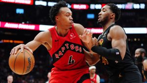 Toronto Raptors' Scottie Barnes (4) protects the ball from Cleveland Cavaliers' Donovan Mitchell (45) during second half NBA playoff basketball action in Toronto on Friday, May 1, 2026. THE CANADIAN PRESS/Frank Gunn