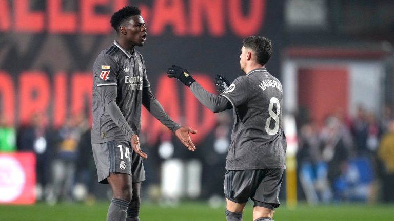 Real Madrid's Federico Valverde, right, celebrates with Real Madrid's Aurelien Tchouameni after scoring his side's opening goal during the Spanish La Liga soccer match between Rayo Vallecano and Real Madrid at the Vallecas stadium in Madrid, Spain, Saturday, Dec. 14, 2024. (AP Photo/Manu Fernandez)