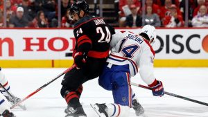 Carolina Hurricanes' Seth Jarvis (24) collides with Montréal Canadiens' Nick Suzuki (14) during the first period in Game 1 of the Eastern Conference finals NHL hockey Stanley Cup playoffs series in Raleigh, N.C., Thursday, May 21, 2026. (Karl DeBlaker/AP)