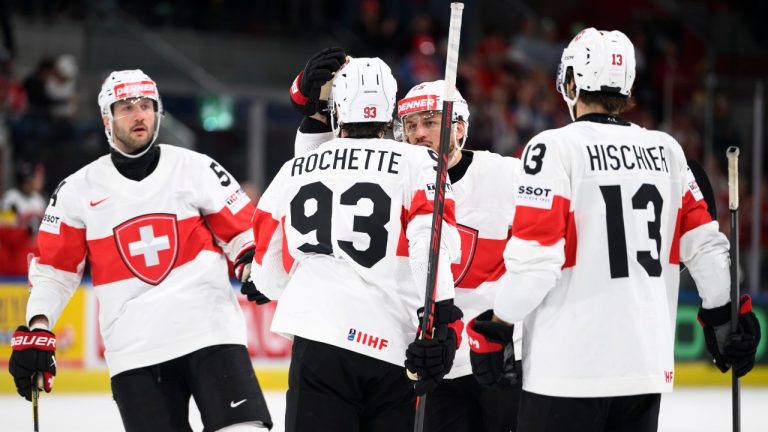 From left, Switzerland's Christian Marti, Switzerland's Theo Rochette, Switzerland's Sven Andrighetto and Switzerland's Nico Hischier celebrate their side's seventh goal during the 2026 IIHF Men's Ice Hockey World Championship preliminary round group A game between Austria and Switzerland, in Zurich, Switzerland, Wednesday, May 20, 2026. (Andreas Becker/Keystone via AP)