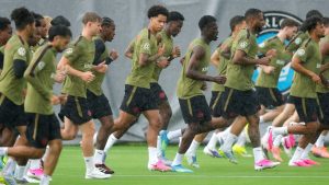 Tajon Buchanan, centre, runs in the rain with his teammates during Team Canada World Cup roster selection camp in Charlotte, N.C., on Tuesday, May 26, 2026. (Nathan Denette/CP)