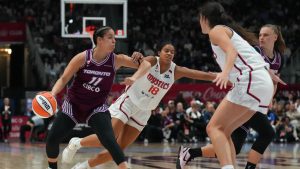 Toronto Tempo's Kia Nurse (11) shields the ball from Washington Mystics' Cassandre Prosper (18) during second half WNBA basketball action in Toronto on Friday, May 8, 2026. (Chris Young/CP)