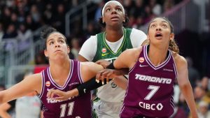 Toronto Tempo's Kia Nurse (11) and Teonni Key (7) box out Seattle Storm's Dominique Malonga (14) on a rebound during first half WNBA basketball action in Toronto, on Wednesday, May 13, 2026. (Frank Gunn/CP)