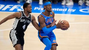 Oklahoma City Thunder guard Shai Gilgeous-Alexander (2) holds the ball as San Antonio Spurs guard De'Aaron Fox (4) defends during the first half of Game 7 of the Western Conference finals of the NBA basketball playoffs series Saturday, May 30, 2026, in Oklahoma City. (Tony Gutierrez/AP)