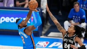 Oklahoma City Thunder guard Shai Gilgeous-Alexander (2) shoots over San Antonio Spurs guard Devin Vassell (24) during the first half of Game 7 of the Western Conference finals of the NBA basketball playoffs series Saturday, May 30, 2026, in Oklahoma City. (AP Photo/Tony Gutierrez)