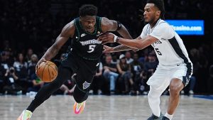 Minnesota Timberwolves guard Anthony Edwards, left, drives against San Antonio Spurs guard Stephon Castle, right, during the first half of Game 6 of an NBA basketball second-round playoffs series in Minneapolis, Friday, May 15, 2026. (AP Photo/Abbie Parr)