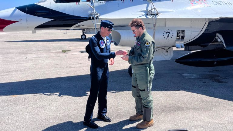 Florida Panthers forward Matthew Tkachuk, right, admires a pin given to him by Lt. Col. Tyler Wrath Keener after Tkachuk flew as a passenger in a Thunderbirds F-16 Fighting Falcon, Friday, May 8, 2026, in Dania Beach, Fla., in advance of the Fort Lauderdale Air Show. (Tim Reynolds/AP)