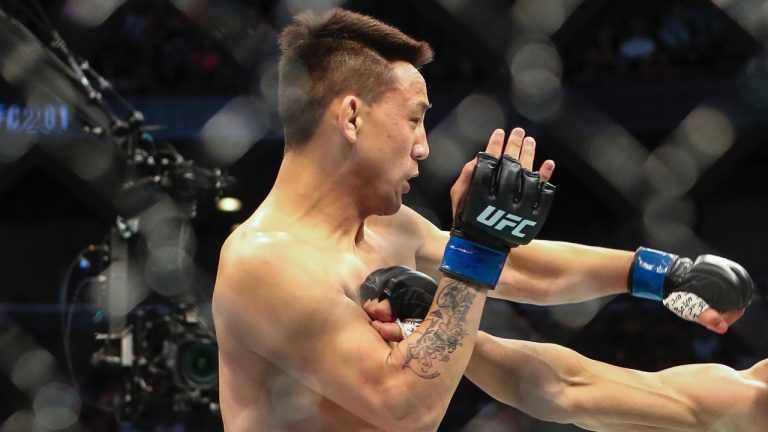 Lightweight fighter Rongzhu of China exchange blows during a UFC mixed martial arts bout. (Gary McCullough/AP)