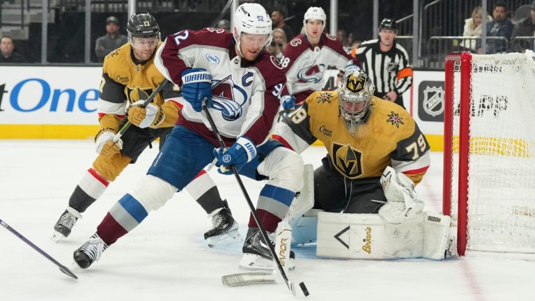 Colorado Avalanche left wing Gabriel Landeskog (92) skates the puck against Vegas Golden Knights goaltender Carter Hart (79) during the third period of an NHL hockey game Saturday, Dec. 27, 2025, in Las Vegas. (AP Photo/Candice Ward)