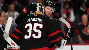 Ottawa Senators' Brady Tkachuk (7) embraces goaltender Linus Ullmark (35) after their team was eliminated by the Carolina Hurricanes at the end of third period of first round Game 4 NHL playoff hockey action in Ottawa, on Saturday, April 25, 2026. THE CANADIAN PRESS/Justin Tang