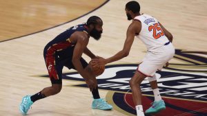 Cleveland Cavaliers guard James Harden, left, controls the ball against New York Knicks guard Mikal Bridges (25) during the first half of Game 3 in the Eastern Conference finals NBA basketball playoffs series in Cleveland, Saturday, May 23, 2026. (AP Photo/Tim Phillis)