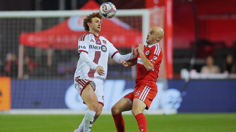 Toronto FC forward Josh Sargent, left, and Chicago Fire defender Andrew Gutman battle for the ball during the second half of an MLS soccer match Saturday, May 23, 2026, in Chicago. (AP Photo/Melissa Tamez)