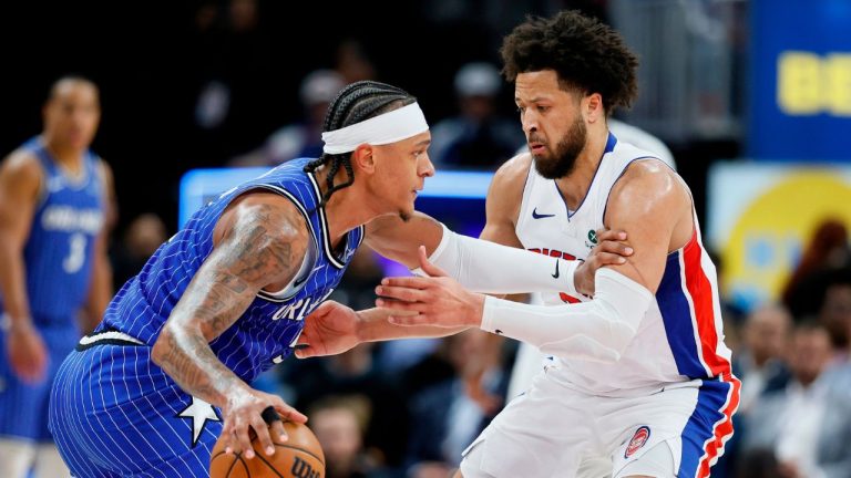 Orlando Magic forward Paolo Banchero, left, drives against Detroit Pistons guard Cade Cunningham, right, during the first half in Game 7 of a first-round NBA basketball playoffs series Sunday, May 3, 2026, in Detroit. (AP Photo/Duane Burleson)