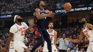 Cleveland Cavaliers guard Donovan Mitchell (45) shoots against New York Knicks center Mitchell Robinson (23) during the second half of Game 3 in the Eastern Conference finals NBA basketball playoffs series in Cleveland, Monday, May 24, 2027. (AP Photo/Sue Ogrocki)