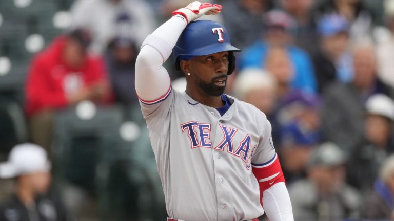Texas Rangers designated hitter Andrew McCutchen (4) in the first inning of a baseball game Wednesday, May 20, 2026, in Denver. (AP Photo/David Zalubowski)
