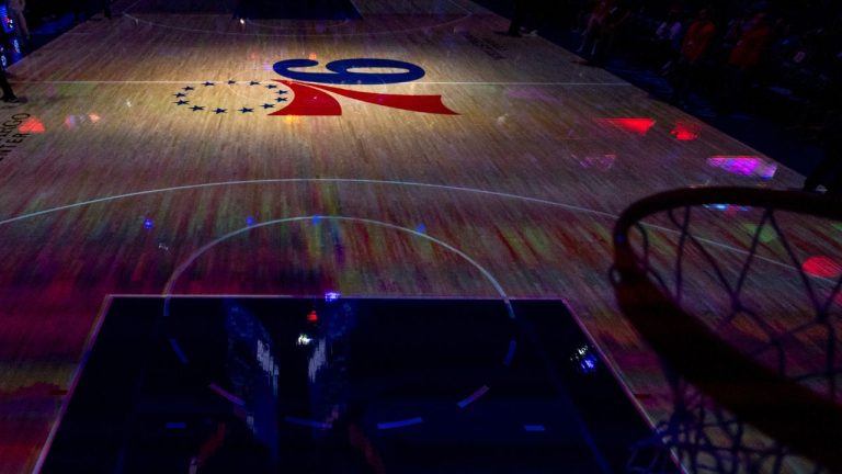 Light highlights the Philadelphia 76ers logo prior to the NBA basketball game against the Detroit Pistons, Wednesday, Oct. 30, 2024, in Philadelphia. The Pistons won 105-95. (AP Photo/Chris Szagola)