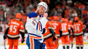 Edmonton Oilers centre Connor McDavid wipes his visor as members of the Anaheim Ducks celebrate after Game 6 of the first round of the Stanley Cup Playoffs Thursday, April 30, 2026, in Anaheim, Calif. (AP Photo/Mark J. Terrill)
