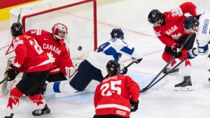 Finland's Aleksander Barkov, center, scores a goal during the semifinal game between Finland and Canada at the men's ice hockey world championship, Saturday, May 30, 2026, in Zurich, Switzerland. (Cyril Zingaro/Keystone via AP)