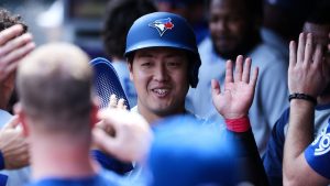 Toronto Blue Jays' Kazuma Okamoto celebrates after scoring on a bases-loaded walk during the eighth inning against the Minnesota Twins, Saturday, May 2, 2026, in Minneapolis. (AP Photo/Matt Krohn)