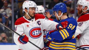 Montreal Canadiens center Nick Suzuki, left, pushes Buffalo Sabres center Konsta Helenius (94) during the first period in Game 7 of a second-round NHL hockey Stanley Cup playoff series Monday, May 18, 2026, in Buffalo, N.Y. (Jeffrey T. Barnes/AP)