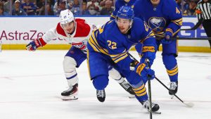 Buffalo Sabres right wing Jack Quinn (22) carries the puck past Montreal Canadiens right wing Cole Caufield (13) during the second period in Game 7 of a second-round NHL hockey Stanley Cup playoff series Monday, May 18, 2026, in Buffalo, N.Y. (Jeffrey T. Barnes/AP)