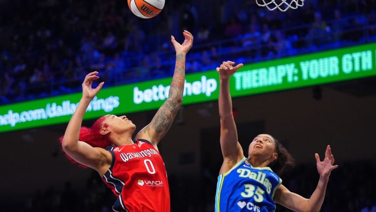 Washington Mystics center Shakira Austin (0) and Dallas Wings guard Azzi Fudd (35) jump for a rebound during the second half of a WNBA game in Arlington, Texas, Monday, May 18, 2026. (LM Otero/AP)