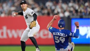 New York Yankees shortstop Anthony Volpe, left, turns a double play over Toronto Blue Jays' Brandon Valenzuela during the seventh inning of a baseball game, Monday, May 18, 2026, in New York. (Seth Wenig/AP)