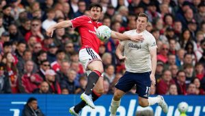 Manchester United's Harry Maguire, left, challenges for the ball with Nottingham Forest's Chris Wood during the English Premier League match between Manchester United and Nottingham Forest in Manchester, England, Sunday, May 17, 2026. (Dave Thompson/AP)
