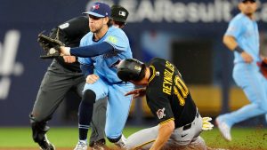 Pittsburgh Pirates left fielder Bryan Reynolds (10) steals second base as the ball arrives too late for Toronto Blue Jays' Ernie Clement to make the tag during third inning MLB baseball action in Toronto on Sunday, May 24, 2026. (Frank Gunn/AP)