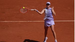 Iga Swiatek of Poland returns to Emerson Jones of Australia during their first round women's singles tennis match at the French Open tennis tournament in Paris, Monday, May 25, 2026. (Thibault Camus/AP)