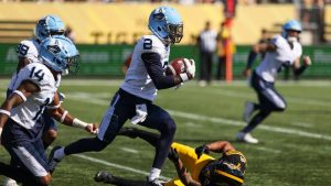 Toronto Argonauts' Tarvarus Mcfadden runs the ball after making an interception during first half CFL Labour Day Classic football action against the Hamilton Tiger-Cats in Hamilton on Monday, September 1, 2025. (Nick Iwanyshyn/CP)