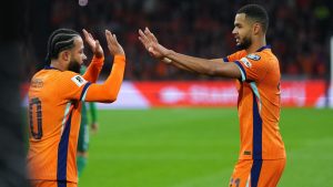 Netherlands' Cody Gakpo is congratulated by Memphis Depay after scoring his side's 2nd goal from the penalty spot during a World Cup 2026 group G qualifying soccer match between Netherlands and Lithuania in Amsterdam, Netherlands, Monday, Nov. 17, 2025. (Peter Dejong/AP)