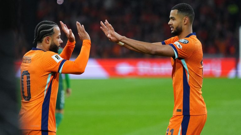 Netherlands' Cody Gakpo is congratulated by Memphis Depay after scoring his side's 2nd goal from the penalty spot during a World Cup 2026 group G qualifying soccer match between Netherlands and Lithuania in Amsterdam, Netherlands, Monday, Nov. 17, 2025. (Peter Dejong/AP)