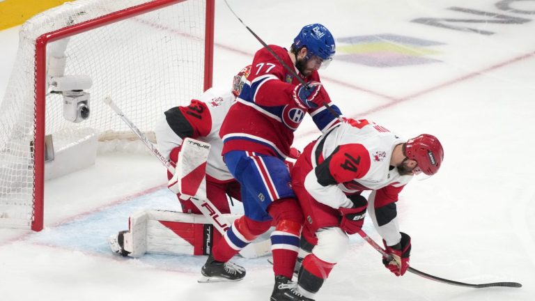 Carolina Hurricanes defenceman Jaccob Slavin tries to clear the puck from in front of teammate Frederik Andersen as Montreal Canadiens centre Kirby Dach attempts to knock him down during first period of Game 3 of the NHL Eastern Conference final Stanley Cup playoff series in Montreal, Monday, May 25, 2026. (Christinne Muschi/CP)