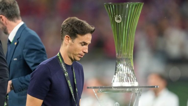 Rayo's head coach Inigo Perez passes the trophy of the Europa Conference League after the final soccer match between Crystal Palace and Rayo Vallecano in Leipzig, Germany, Wednesday, May 27, 2026. (Michael Probst/AP)