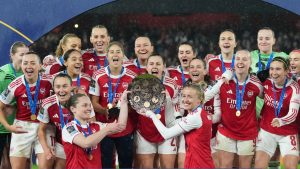 Arsenal's team captains Kin Little, left, and Leah Williamson, right, lift the trophy after winning the Women's Champions Cup final soccer match between Arsenal FC and SC Corinthians in London, Sunday, Feb. 1, 2026. (Alastair Grant/AP)