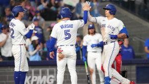 Toronto Blue Jays' Brandon Valenzuela (59) is congratulated on his three run home run as he crosses home plate by teammates Daulton Varsho (5) and Ernie Clement (22) during fifth inning MLB baseball action against the Los Angeles Angels, in Toronto, Saturday, May 9, 2026. THE CANADIAN PRESS/Chris Young