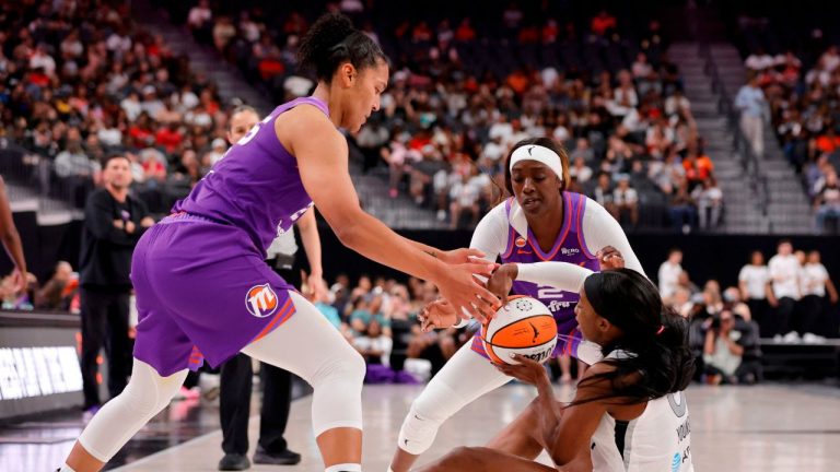 Phoenix Mercury forward Alyssa Thomas, left, and guard/forward Kahleah Copper, back right, defend against Las Vegas Aces guard Jackie Young, front right, during the first half of an WNBA basketball game Saturday, May 9, 2026, in Las Vegas. (Steve Marcus/Las Vegas Sun via AP)