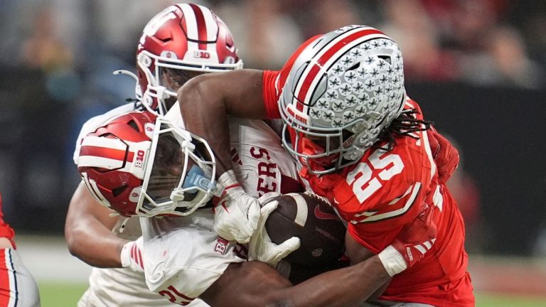 Indiana's Louis Moore tries to stop Ohio State's Bo Jackson during the second half of the Big Ten championship NCAA college football game in Indianapolis, Saturday, Dec. 6, 2025. (Michael Conroy/AP)